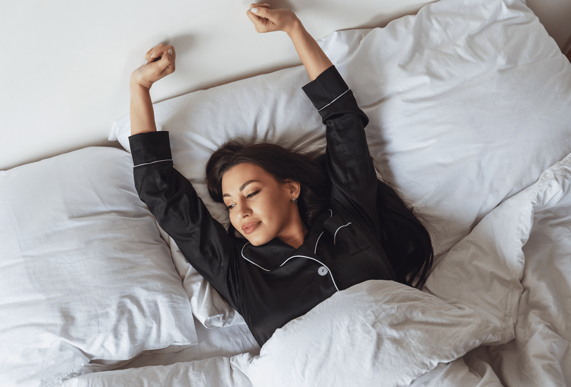 Vrouw met een koptelefoon op bed